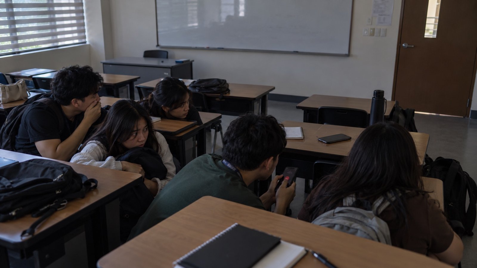 Adult university students sheltering together during a campus emergency